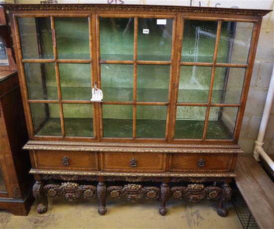 An early 20th century George I style parcel gilt walnut display cabinet, W.148cm, D.44cm, H.148cm